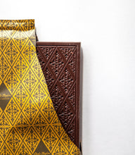 Load image into Gallery viewer, Inner chocolate bar packaging with an open torn off corner revealing the chocolate bar