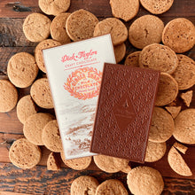 Load image into Gallery viewer, Unopened chocolate bar on Ginger Snap bar packaging on top of a layout of ginger snap cookies.