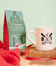 Load image into Gallery viewer, Drinking Chocolate bag next to a Dick Taylor Chocolate branded diner mug.