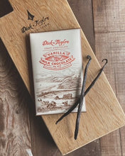 Load image into Gallery viewer, Vanilla Milk Packaging with two vanilla beans on top, on top of a wooden cutting board.