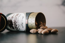 Load image into Gallery viewer, Opened tube of Chocolate Coated Almonds on its side with the chocolate coated almonds spilling out.