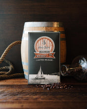 Load image into Gallery viewer, Straight Bourbon Whiskey bar packaging in front of a small barrel with a wooden background that is decorated with rope and a bottle spilling cocoa nibs.
